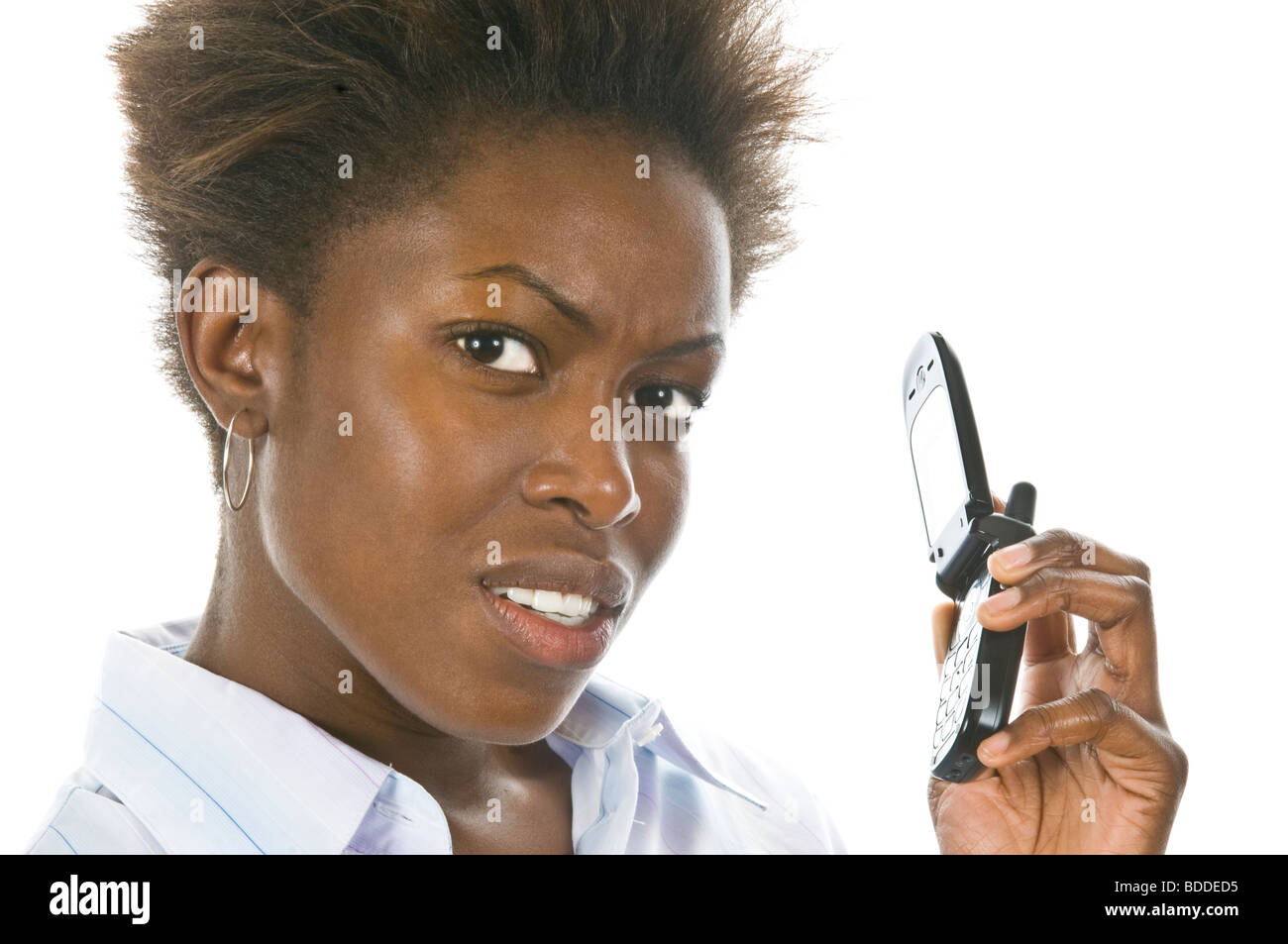 Studio portrait of a young attractive angry African business woman on a mobile phone against a pure white (255) background. Stock Photo