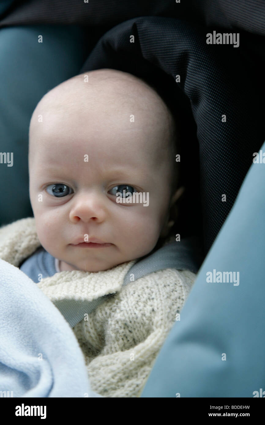 A two month old small baby in a car seat. Model released Stock Photo