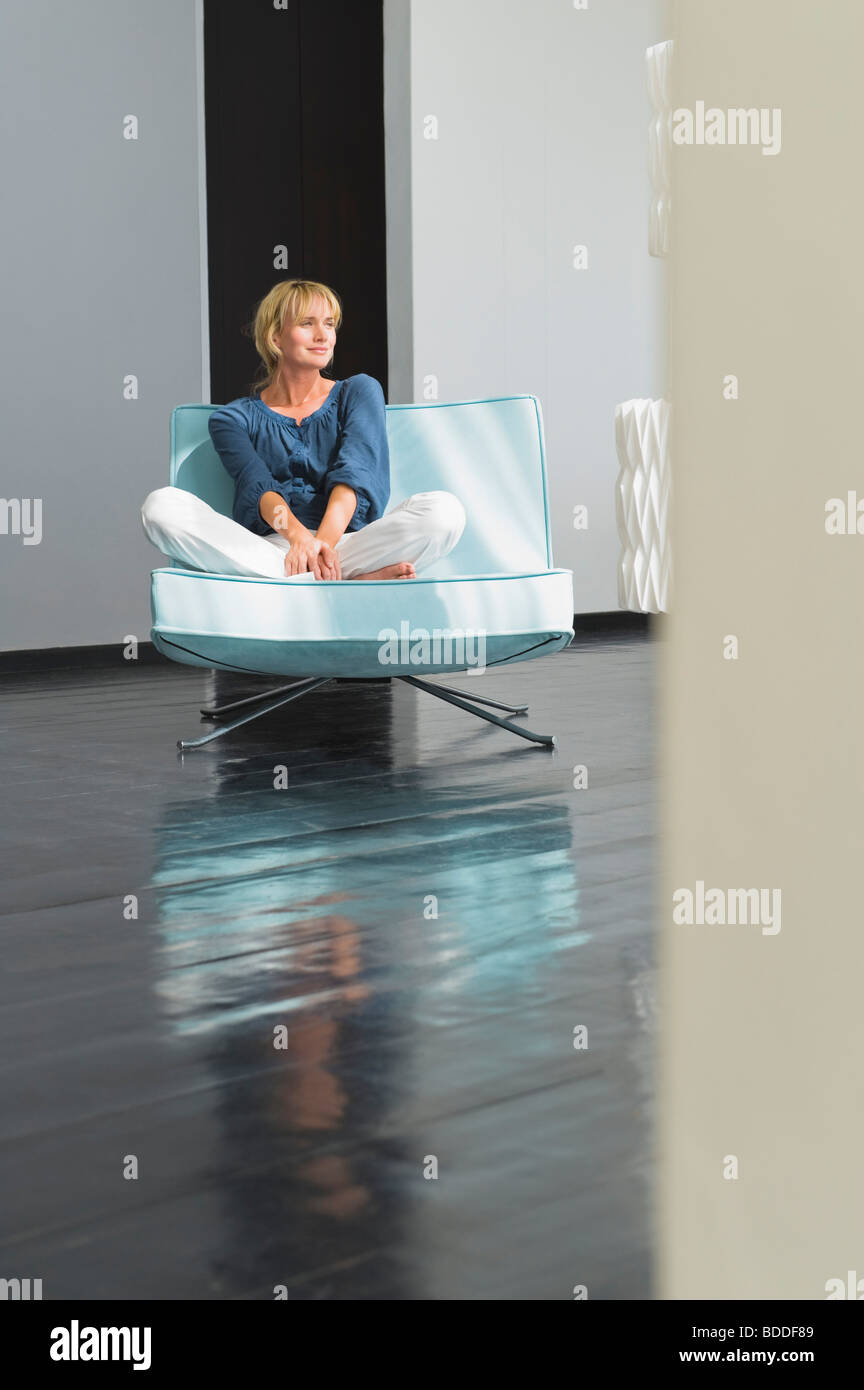 Woman sitting on a couch Stock Photo