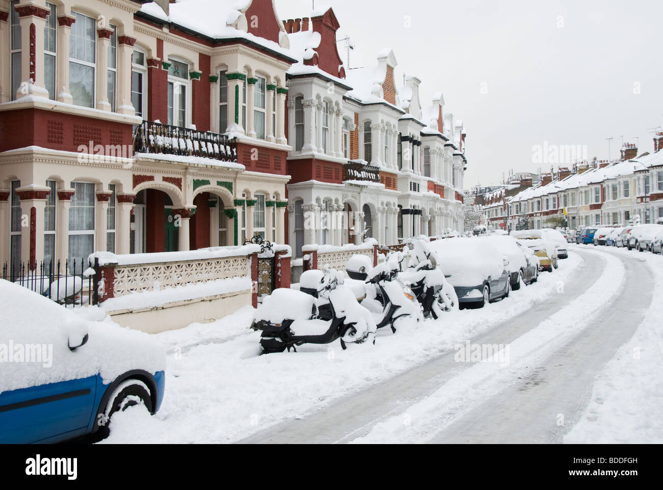 London on a winter morning with vehicles covered in a blanket of snow. Stock Photo