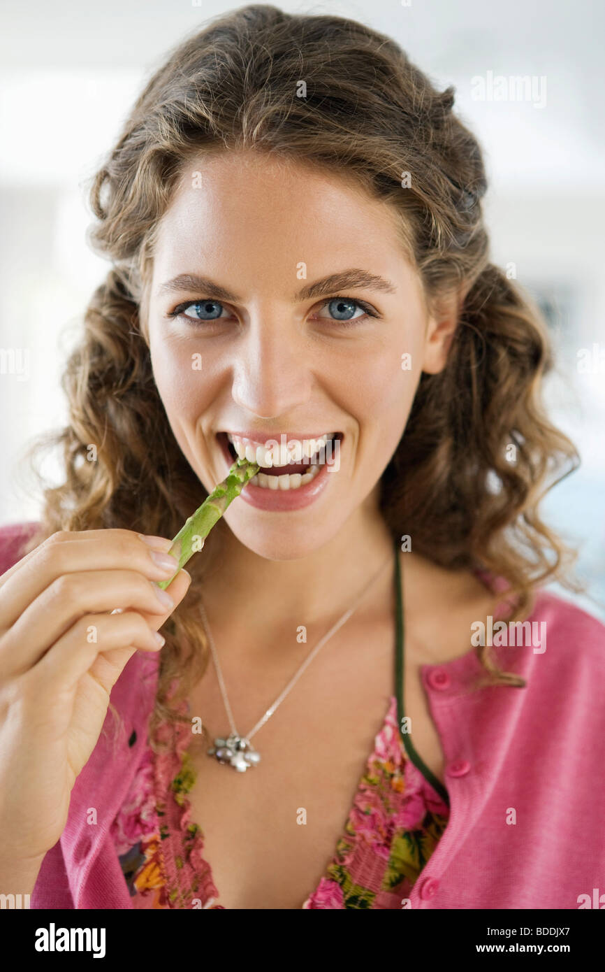 Portrait of a woman eating asparagus Stock Photo Alamy