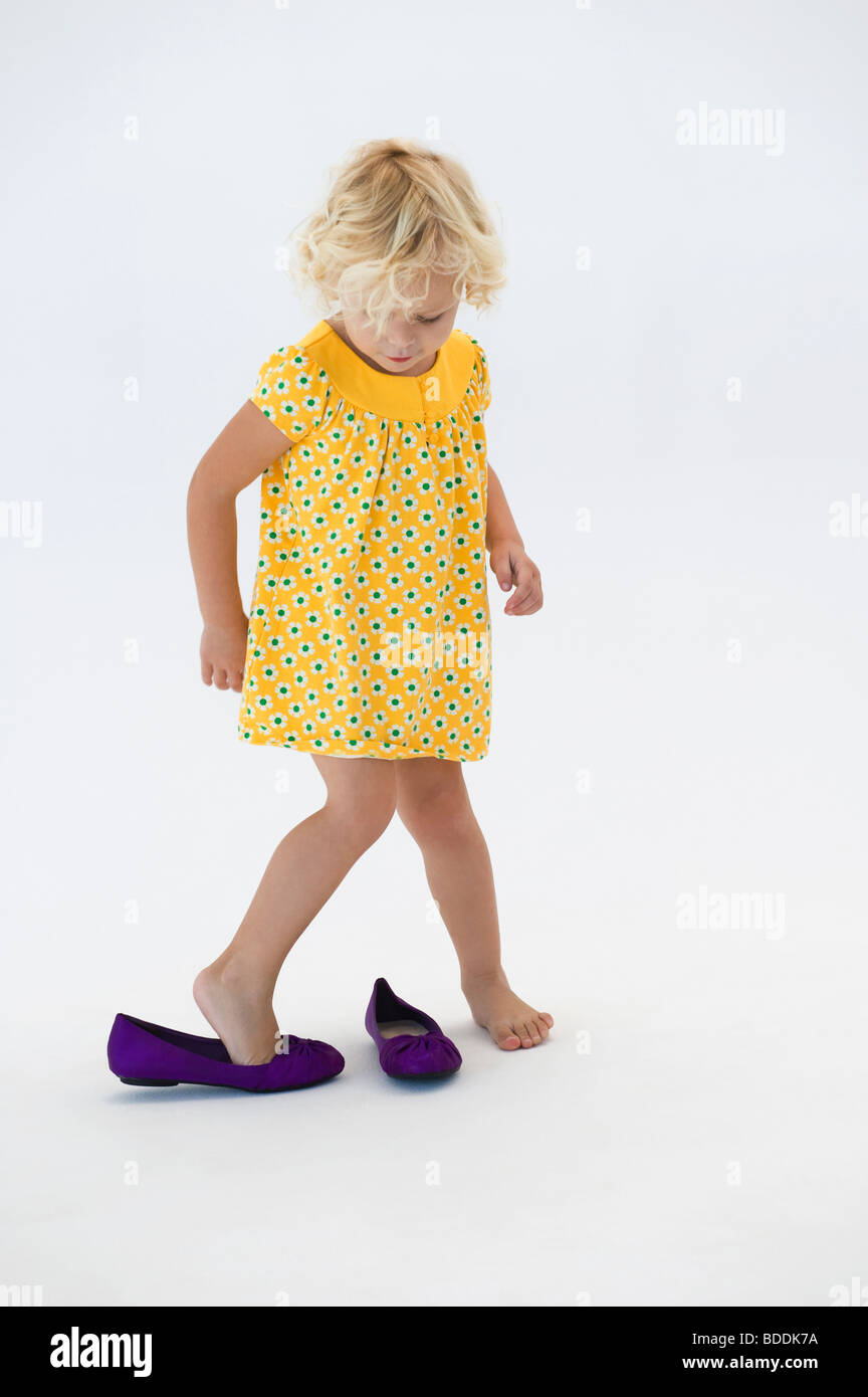 Girl putting on shoes Stock Photo