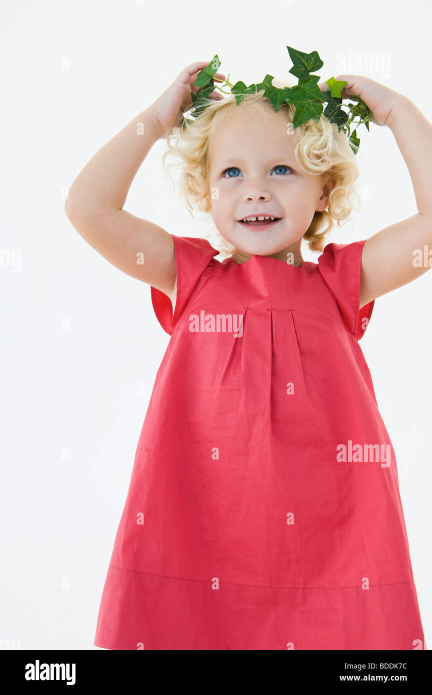 Girl wearing a wreath and smiling Stock Photo - Alamy