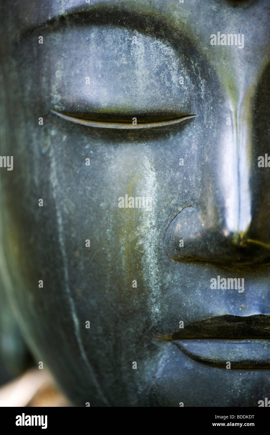 Buddha face garden sculpture Stock Photo