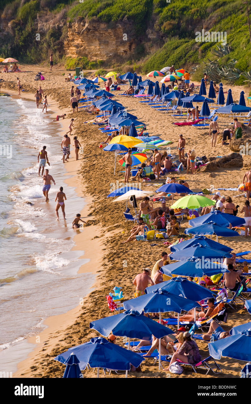 Holidaymakers sunbathing on a crowded Ammes Beach on the Greek Mediterranean island of Kefalonia Greece GR Stock Photo