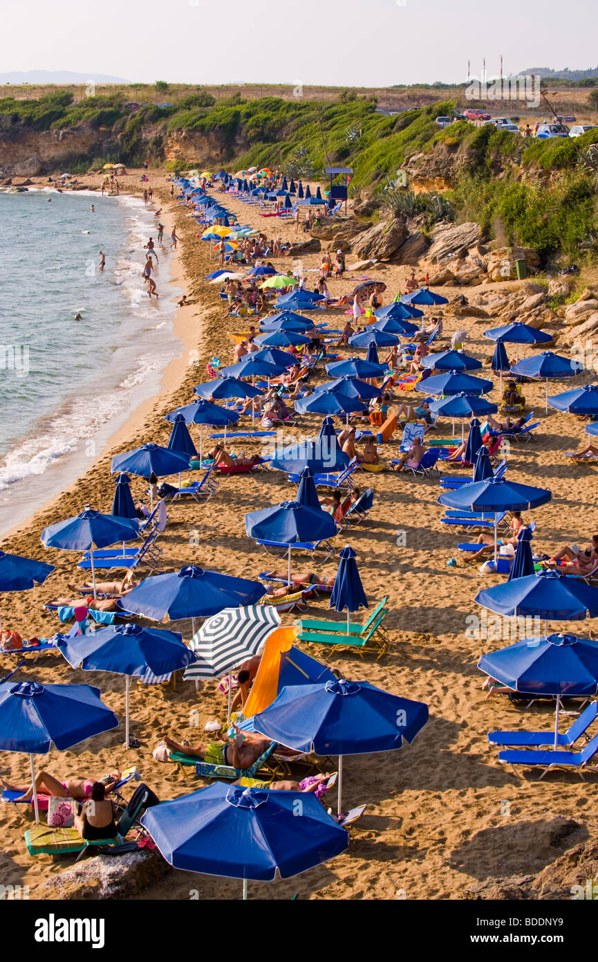 beach holiday. Holidaymakers sunbathing on a crowded Ammes Beach on the Greek Mediterranean island of Kefalonia Greece GR Stock Photo