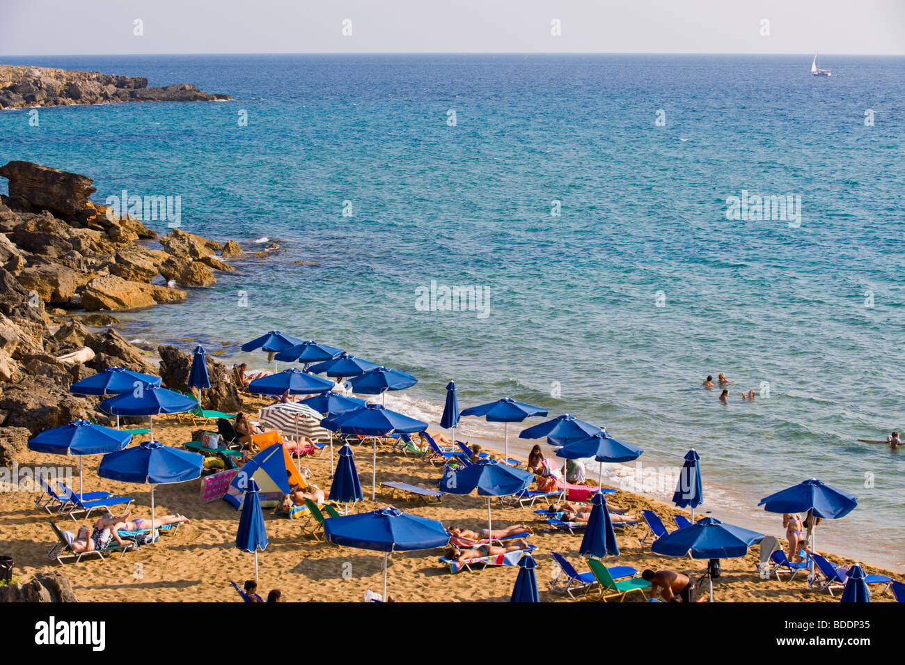 Holidaymakers sunbathing on a crowded Ammes Beach on the Greek Mediterranean island of Kefalonia Greece GR Stock Photo