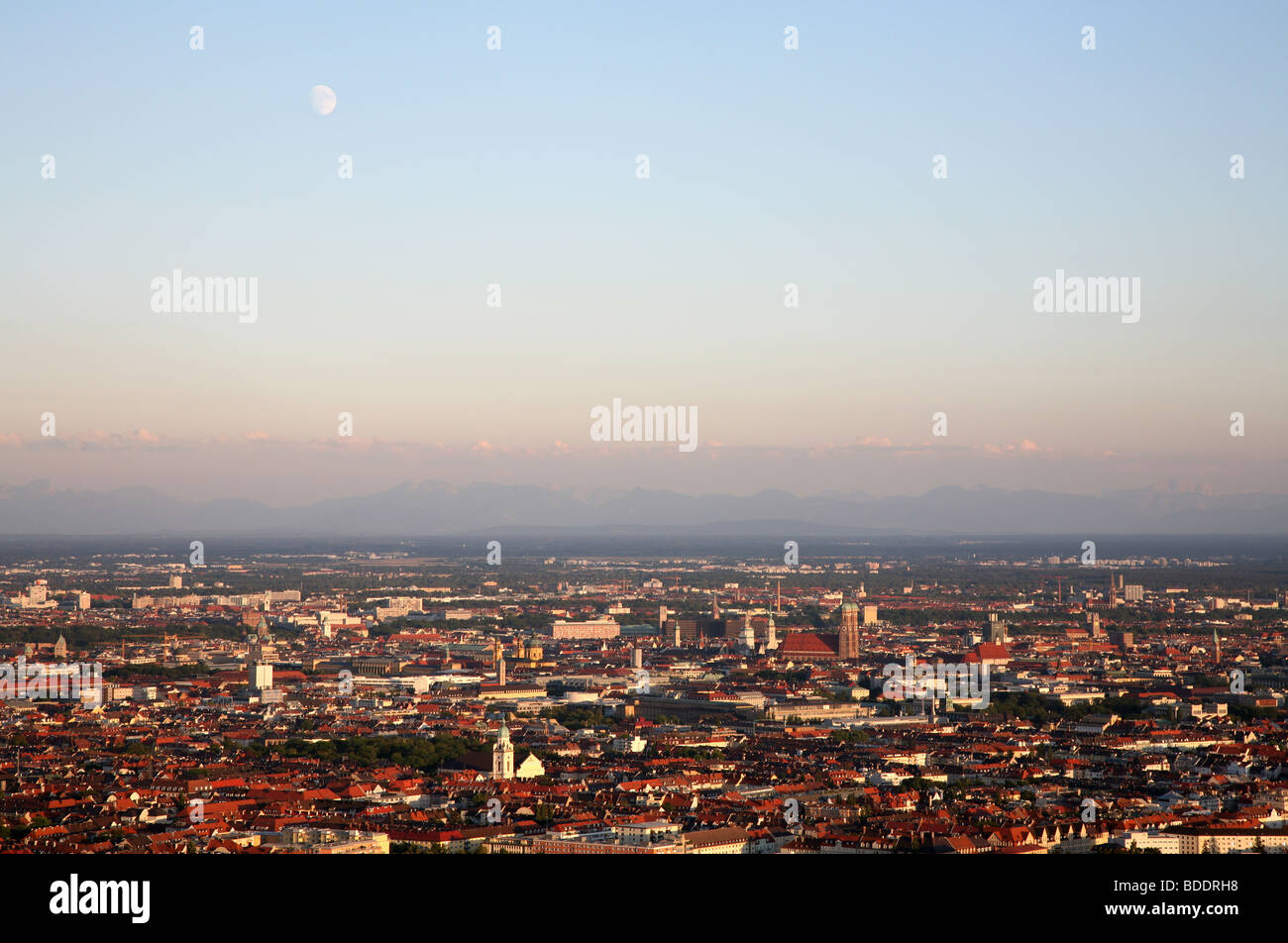 Moonrise over Central Munich and the northern suburbs, and in the distance the foothills of the northern Alps, Germany. Stock Photo
