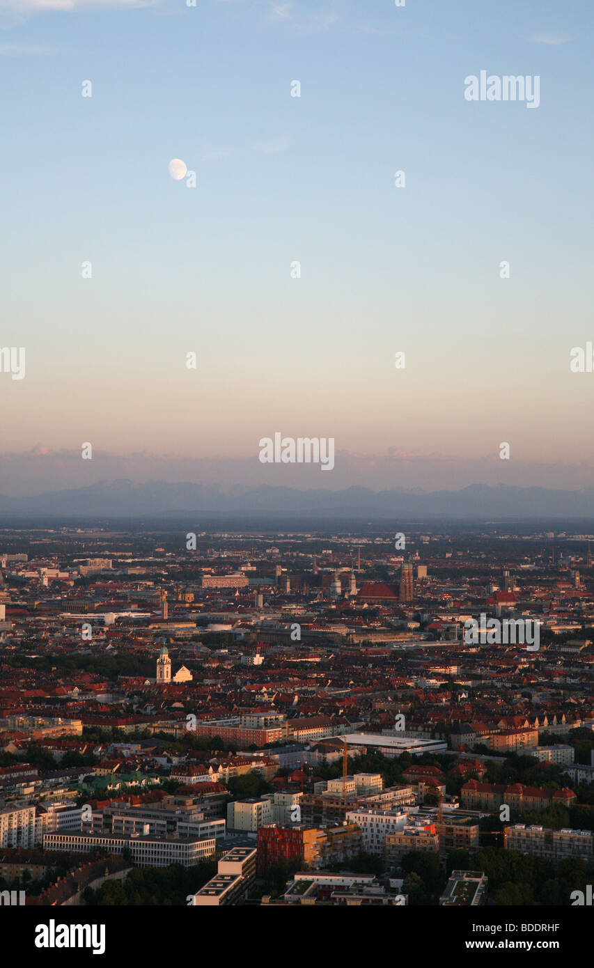 Moonrise over Central Munich and the northern suburbs, and in the distance the foothills of the northern Alps, Germany. Stock Photo
