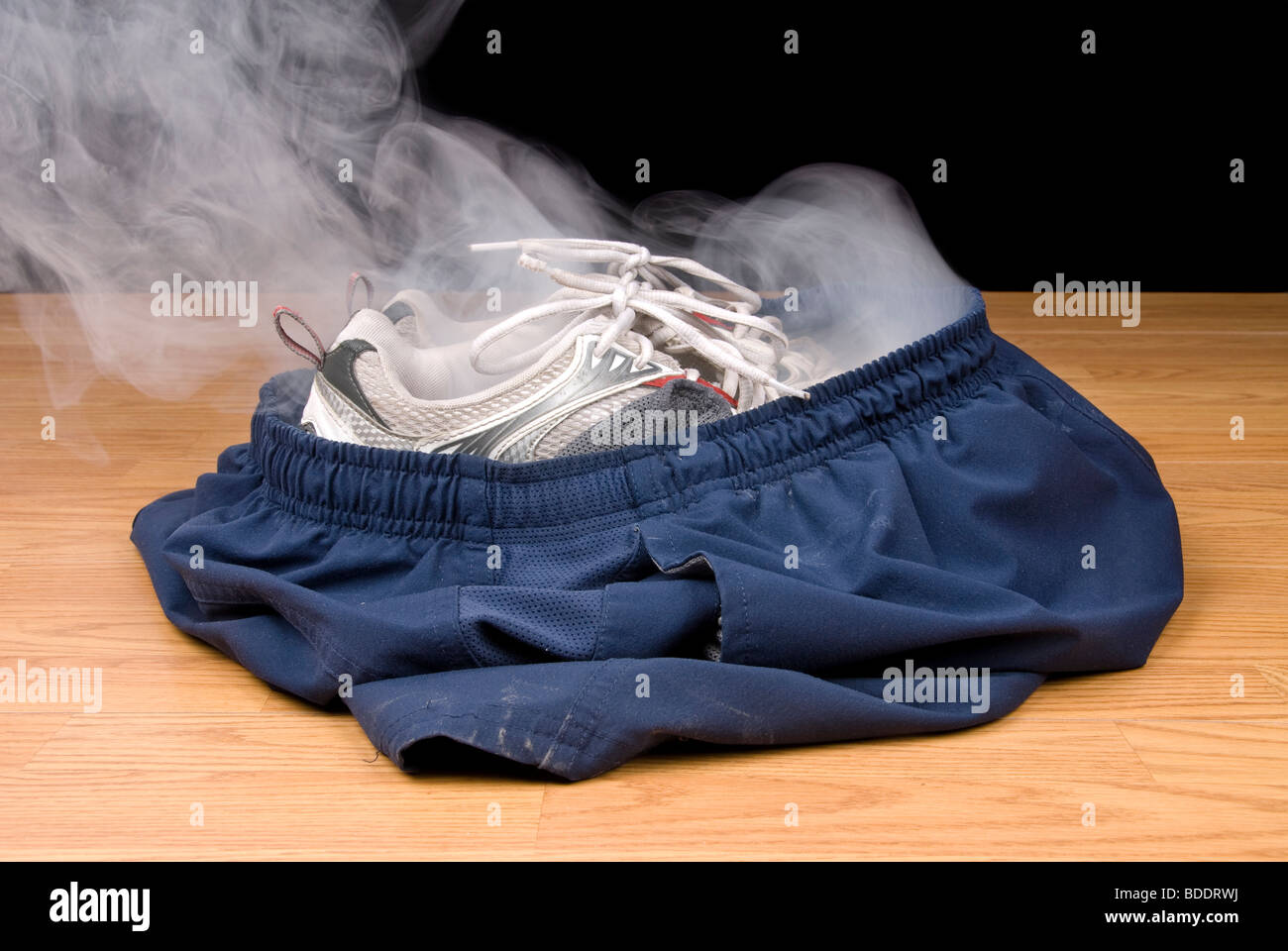 A pair of smoking shoes and shorts remain as the illusion insinuates that a person has vanished right out of their clothing. Stock Photo