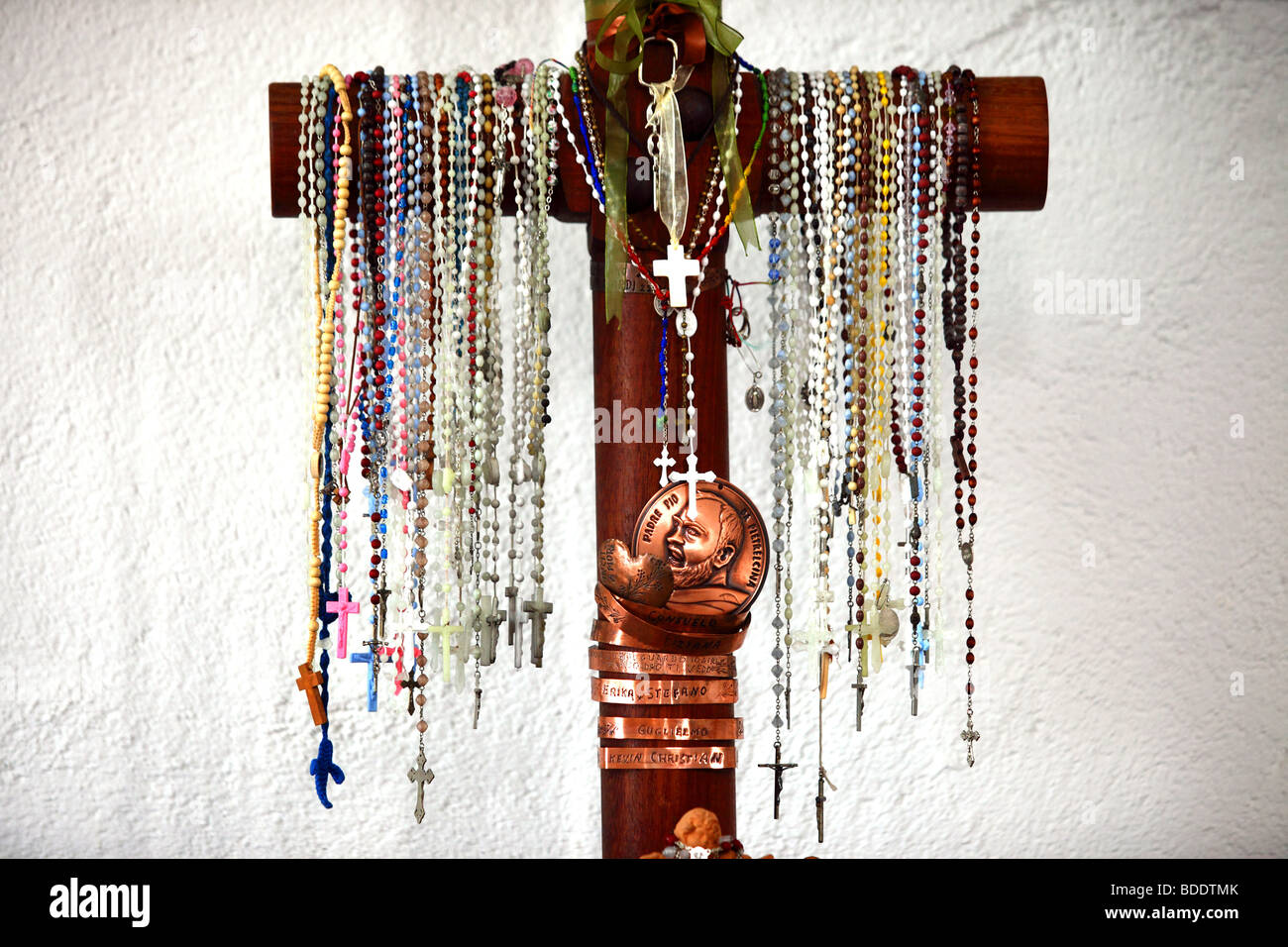 Catholic rosary beads hang on a cross in an Italian church Stock Photo