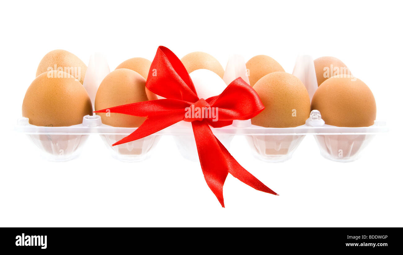 White egg wrapped around with red ribbon and pack isolated on white background Stock Photo