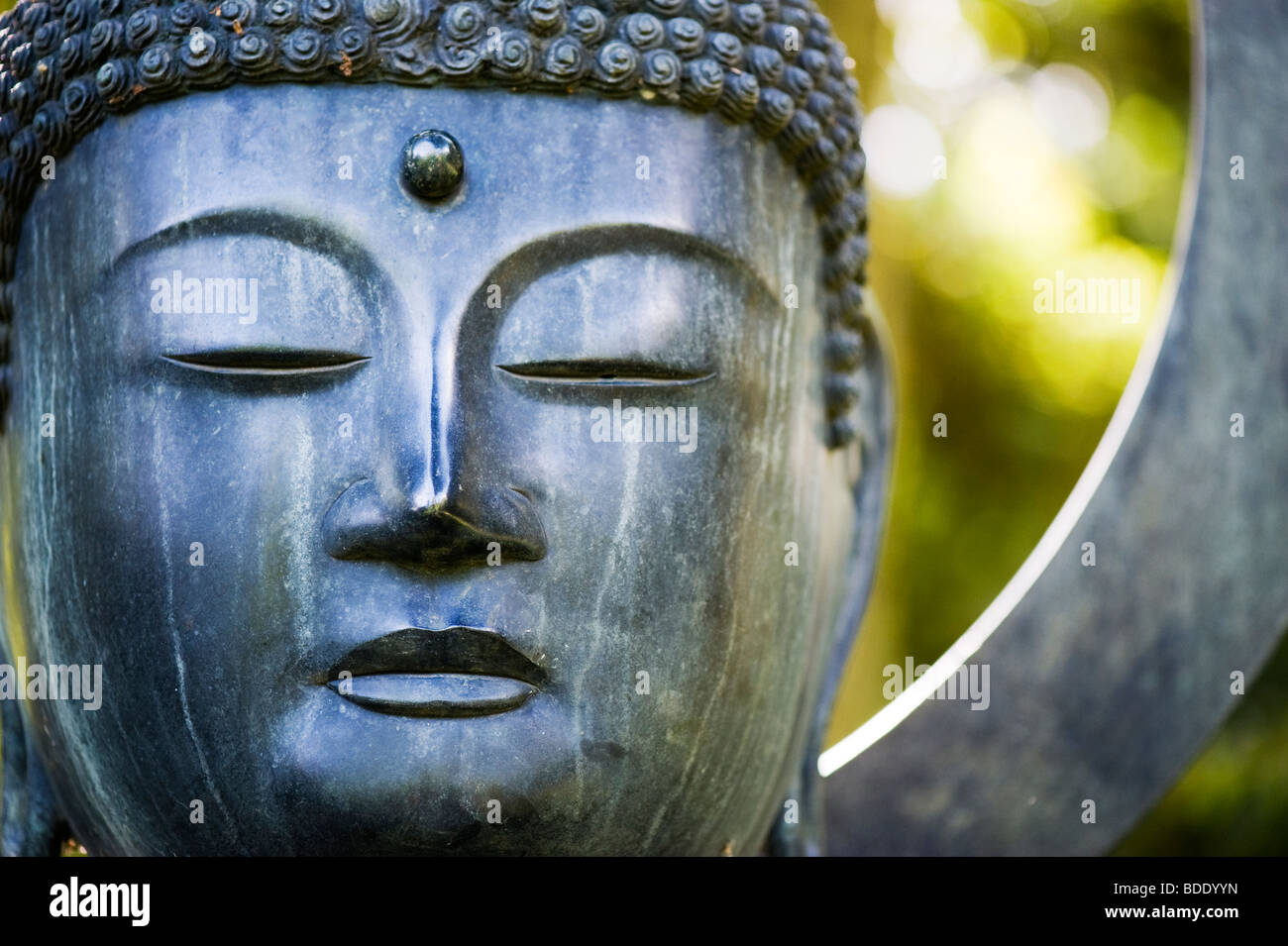 Buddha face garden sculpture Stock Photo
