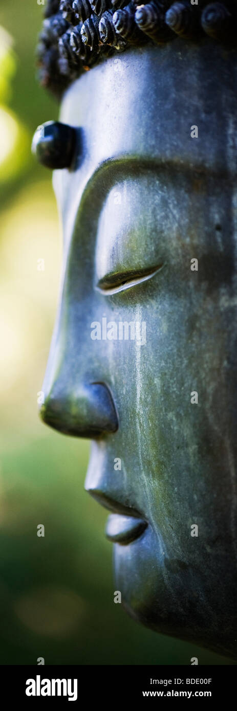 Buddha face garden sculpture Stock Photo