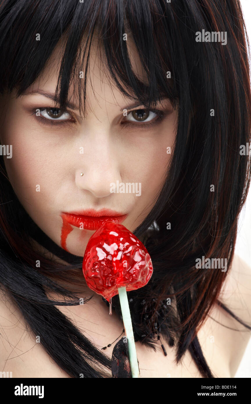 portrait of vampire girl with red sucker Stock Photo