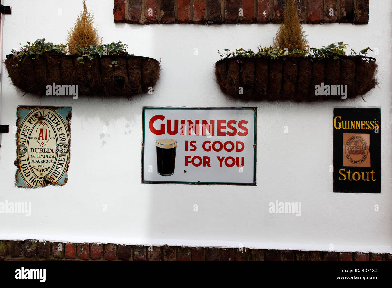 IRELAND, North, Belfast, Cathedral Quarter, Commercial Court, Old metal Guinness signs decorating the  Duke of York pub Stock Photo