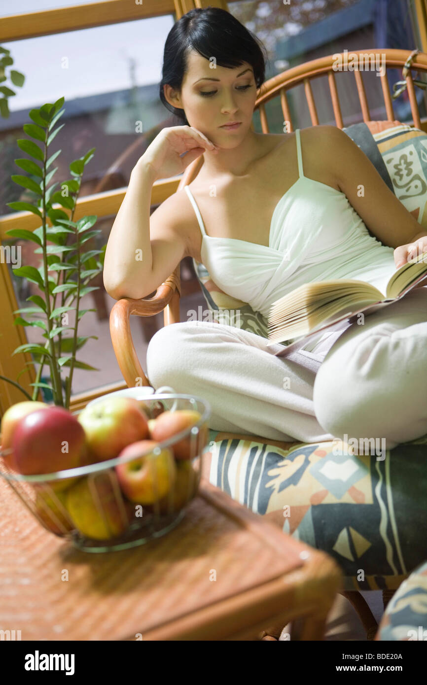 Young woman reading a book in her free time Stock Photo