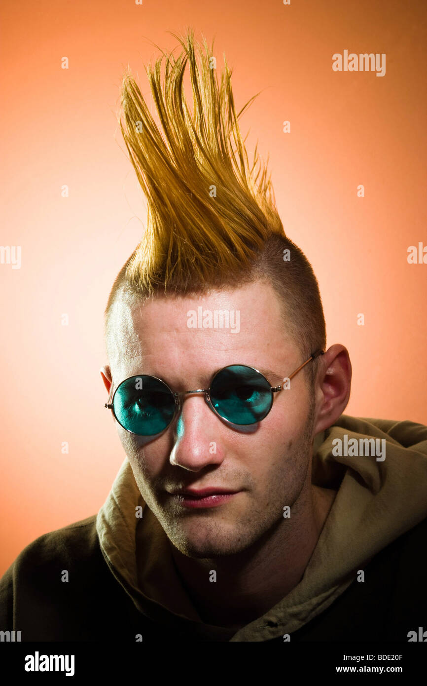 Young man with a Mohawk hairdo, wearing glasses, posing.  MODEL RELEASED. Stock Photo