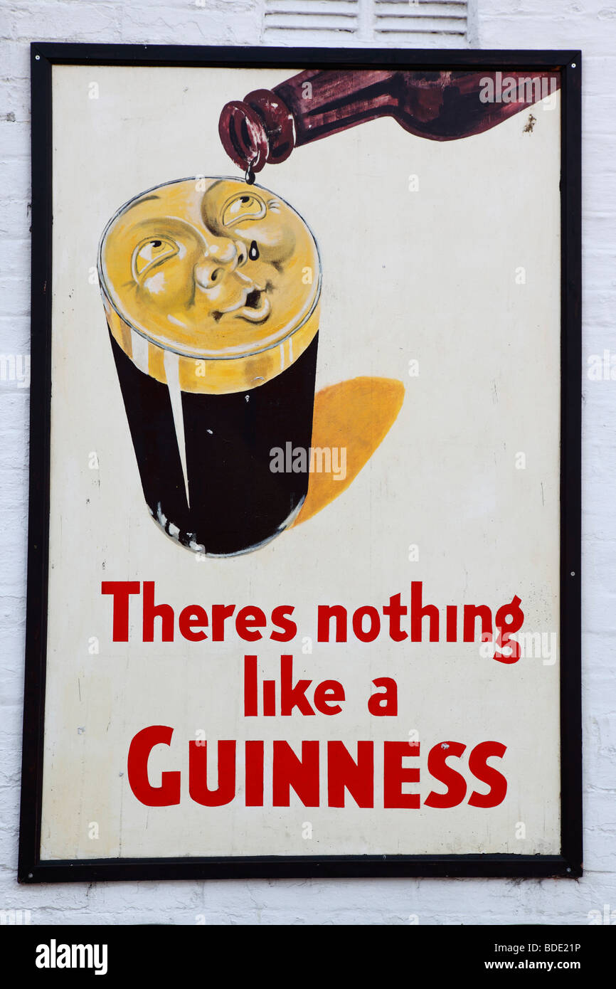 IRELAND, North, Belfast, Bank Square, Old metal Guinness sign decorating the exterior Kelly's Cellars Public House. Stock Photo