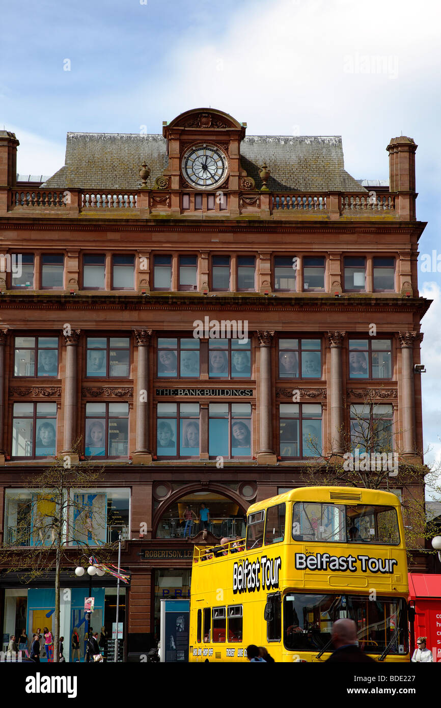 IRELAND, North, Belfast, Castle Street Bank Buildings, former bank of the 4 Johns, now a retail clothing store. Yellow bus Stock Photo