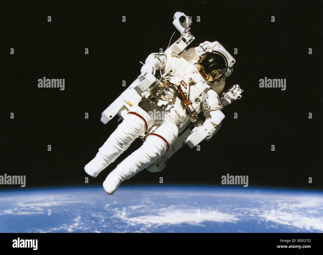 Astronaut floating in orbit above the earth. Stock Photo