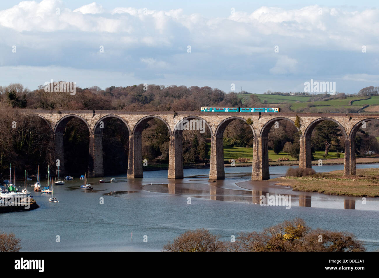 A train travails across the viaduct , which spans the river Tiddy at St Germans Cornwall. Stock Photo