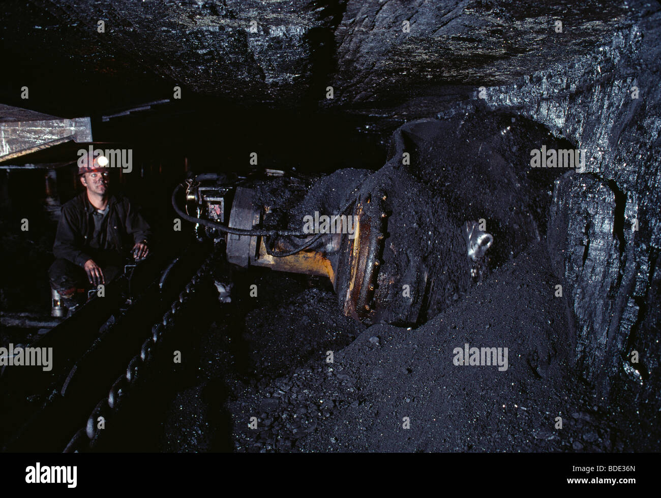 A coal miner operates a shearer that mines a 30 inch cut of coal at 20 feet per minute Stock Photo