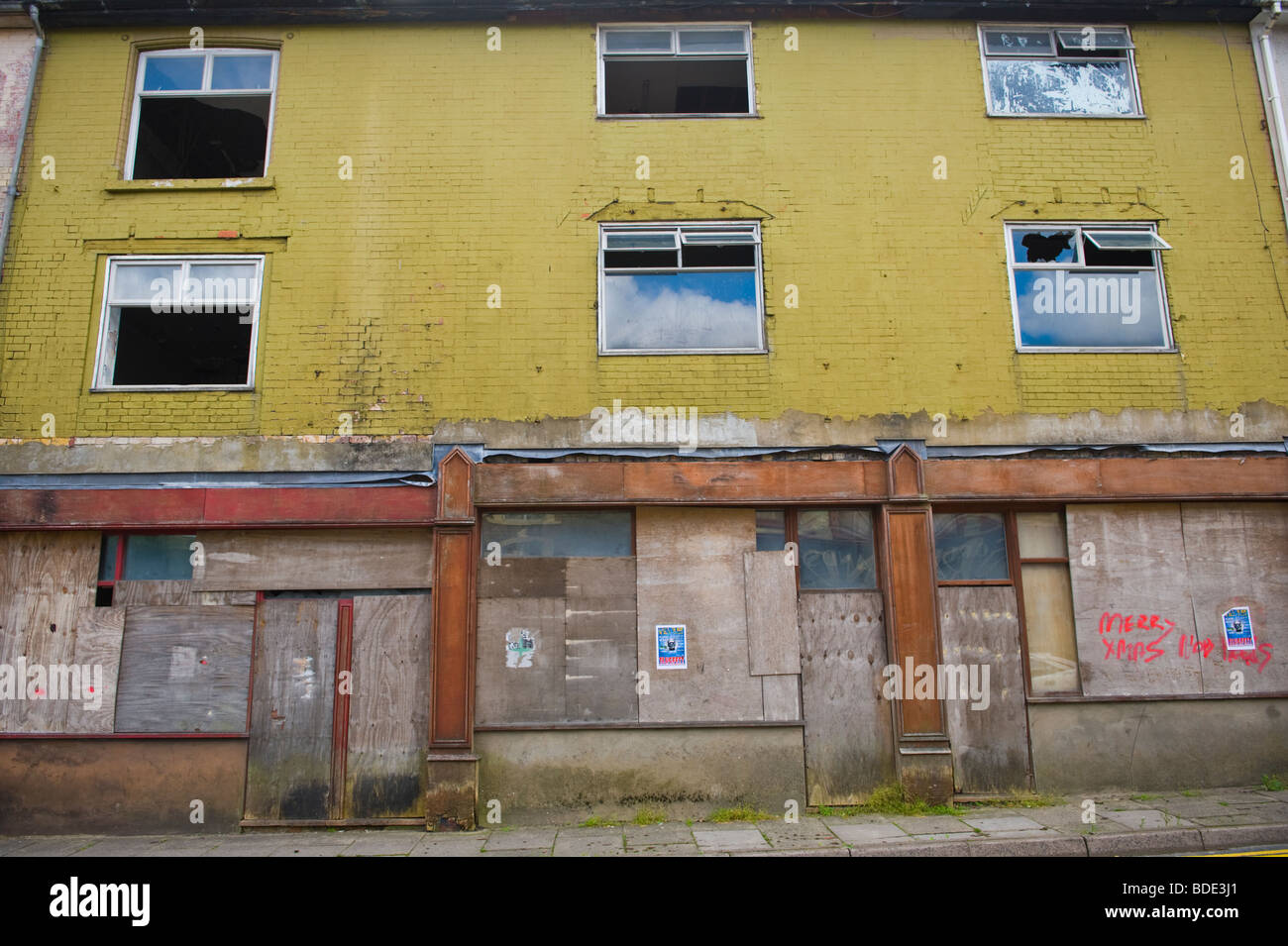 Shops windows and doors boarded up with plywood sheets in Ebbw Vale