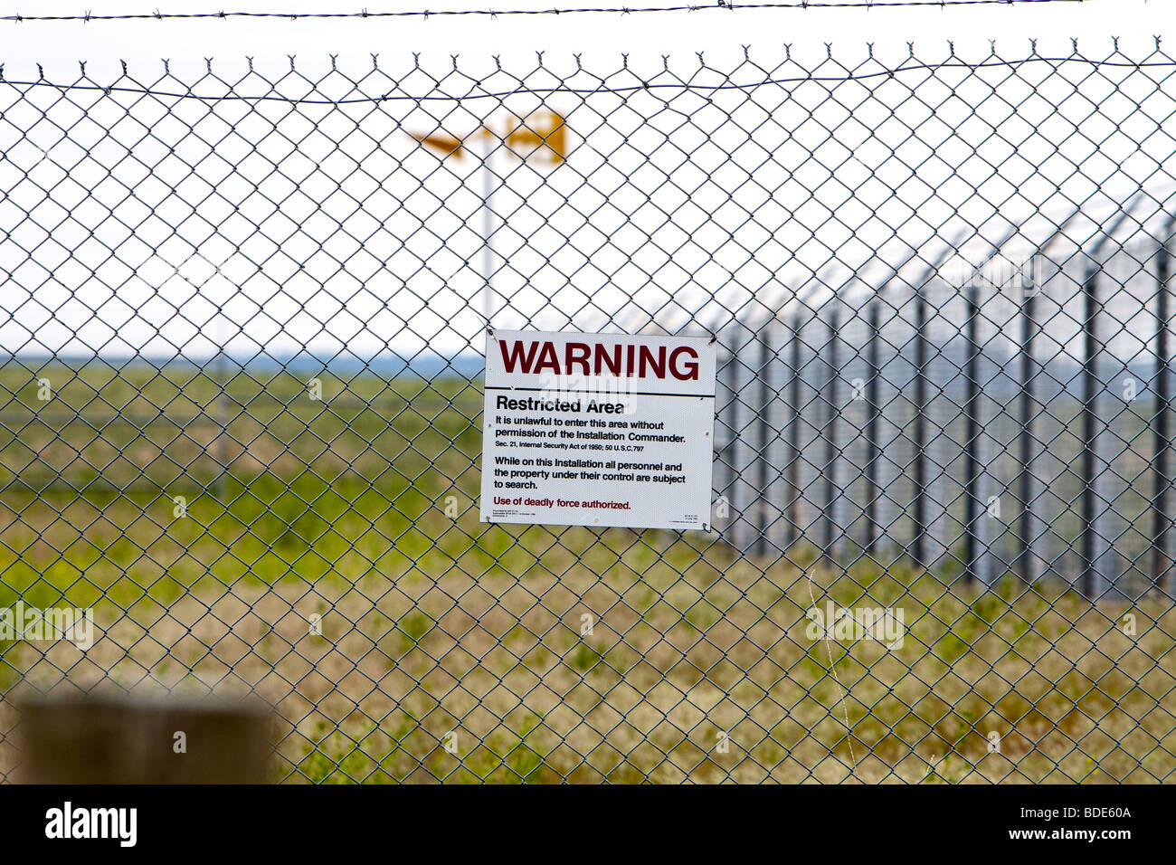 The warning sign on the perimeter fence of a Minuteman 2 missile silo in western Nebraska, USA, June 5, 2009. Stock Photo