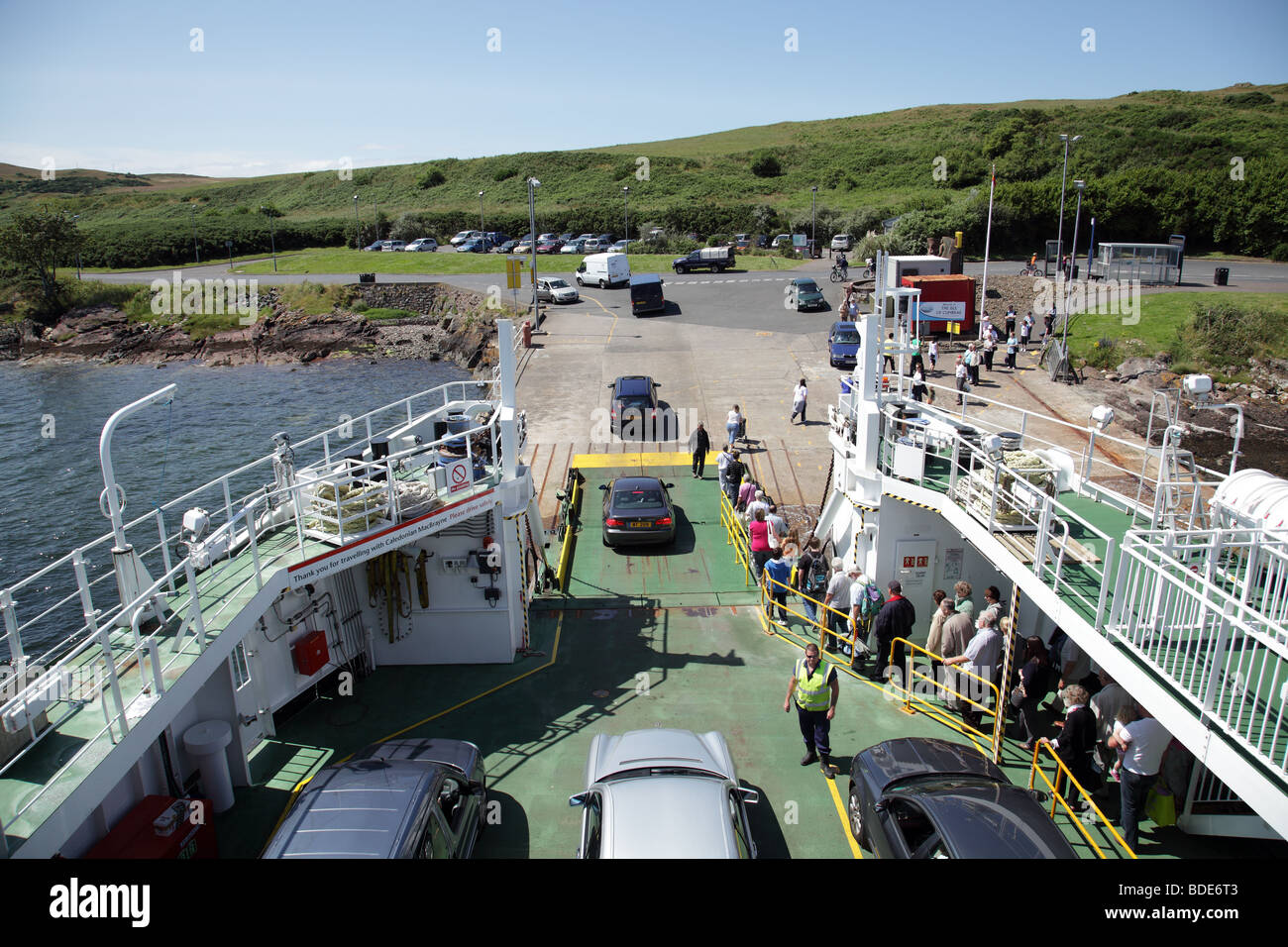 Cars and passengers disembark a Calmac Ferry on Great Cumbrae to head for Millport after sailing from the town of Largs, North Ayrshire, Scotland, UK Stock Photo