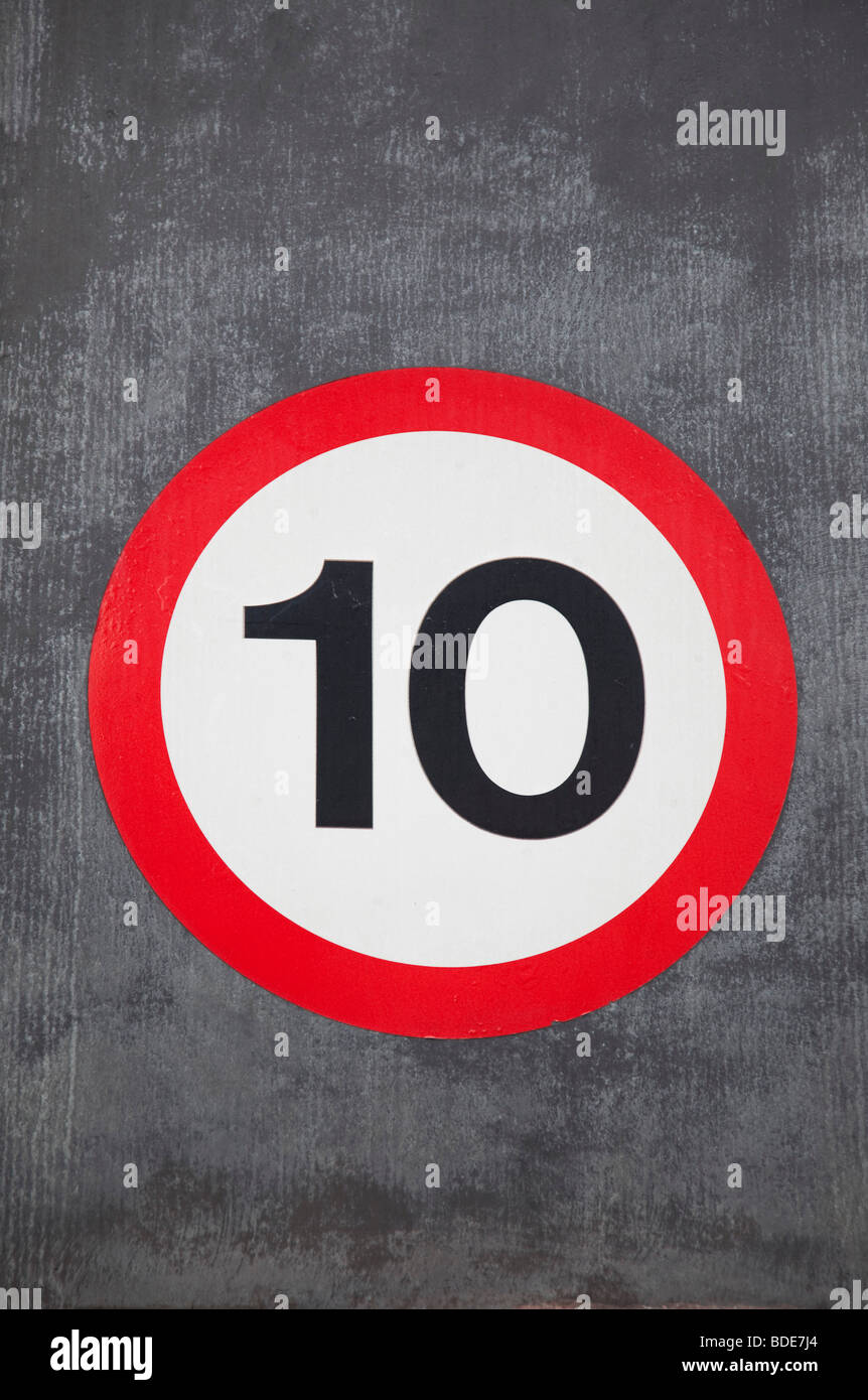 Speed restriction sign reads 10 MPH. Stock Photo