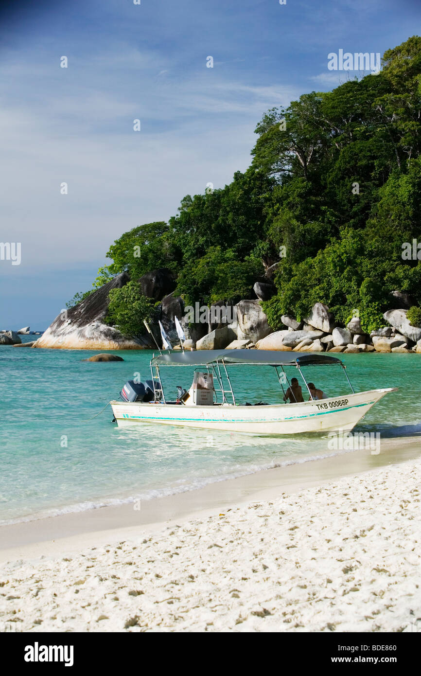 A boat on a paradise beach in Pulau Perhentian, Malaysia. Stock Photo