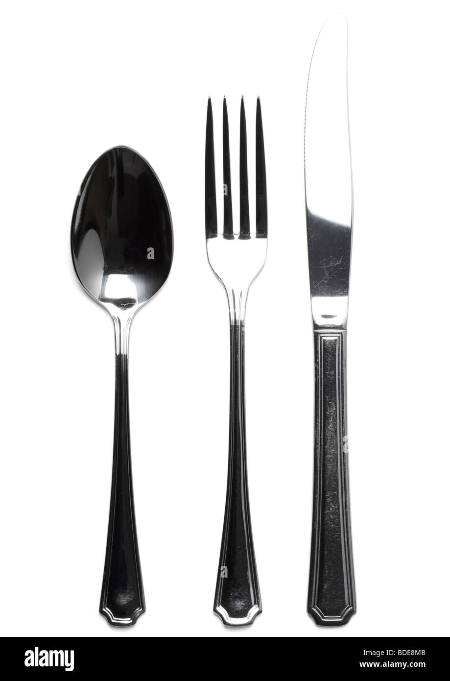 Old knife, fork and dessert spoon on white background Stock Photo