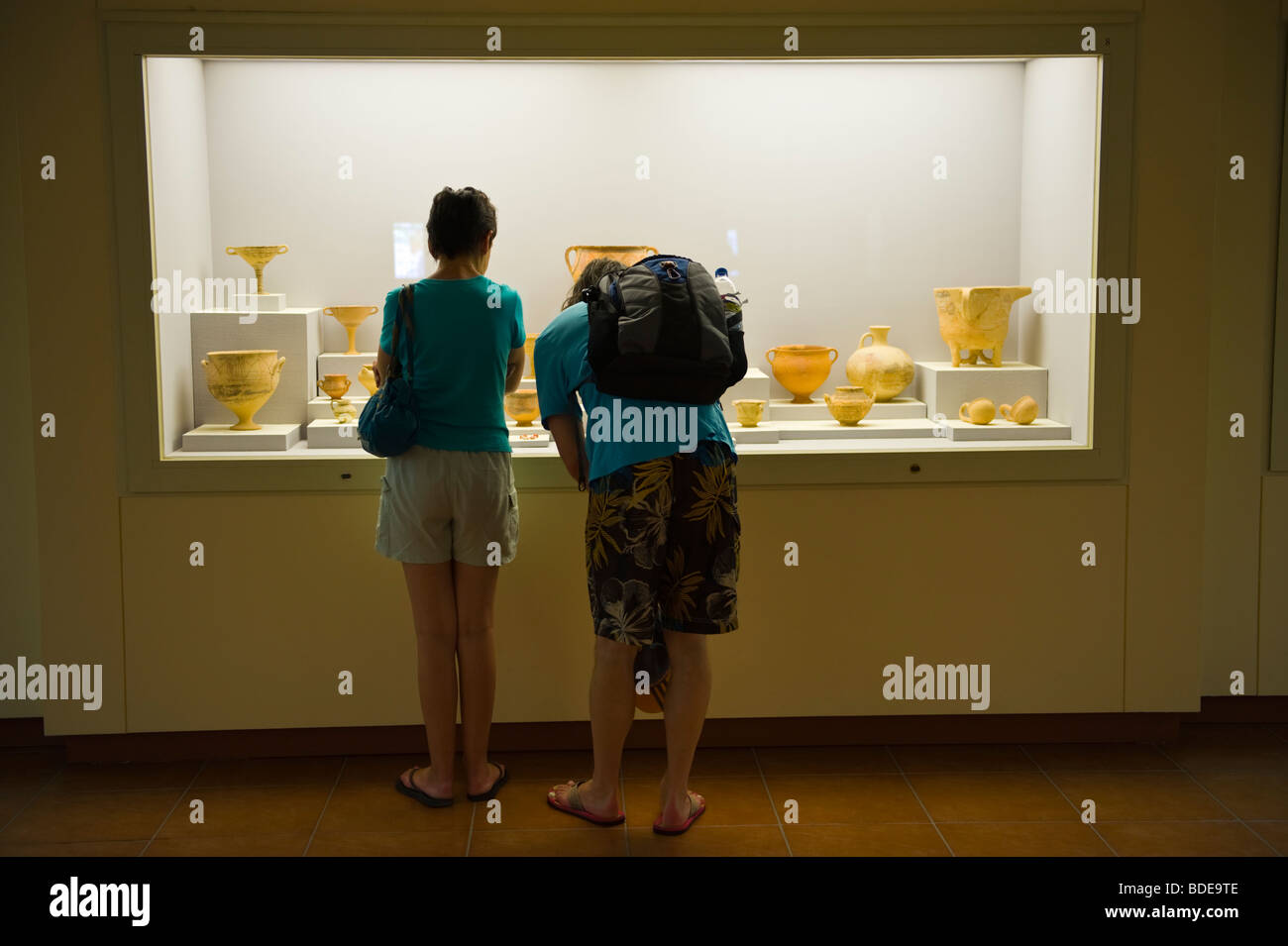 Tourists looking at display cases in the Archaeological Museum at Argostoli on the Greek island of Kefalonia Greece GR Stock Photo