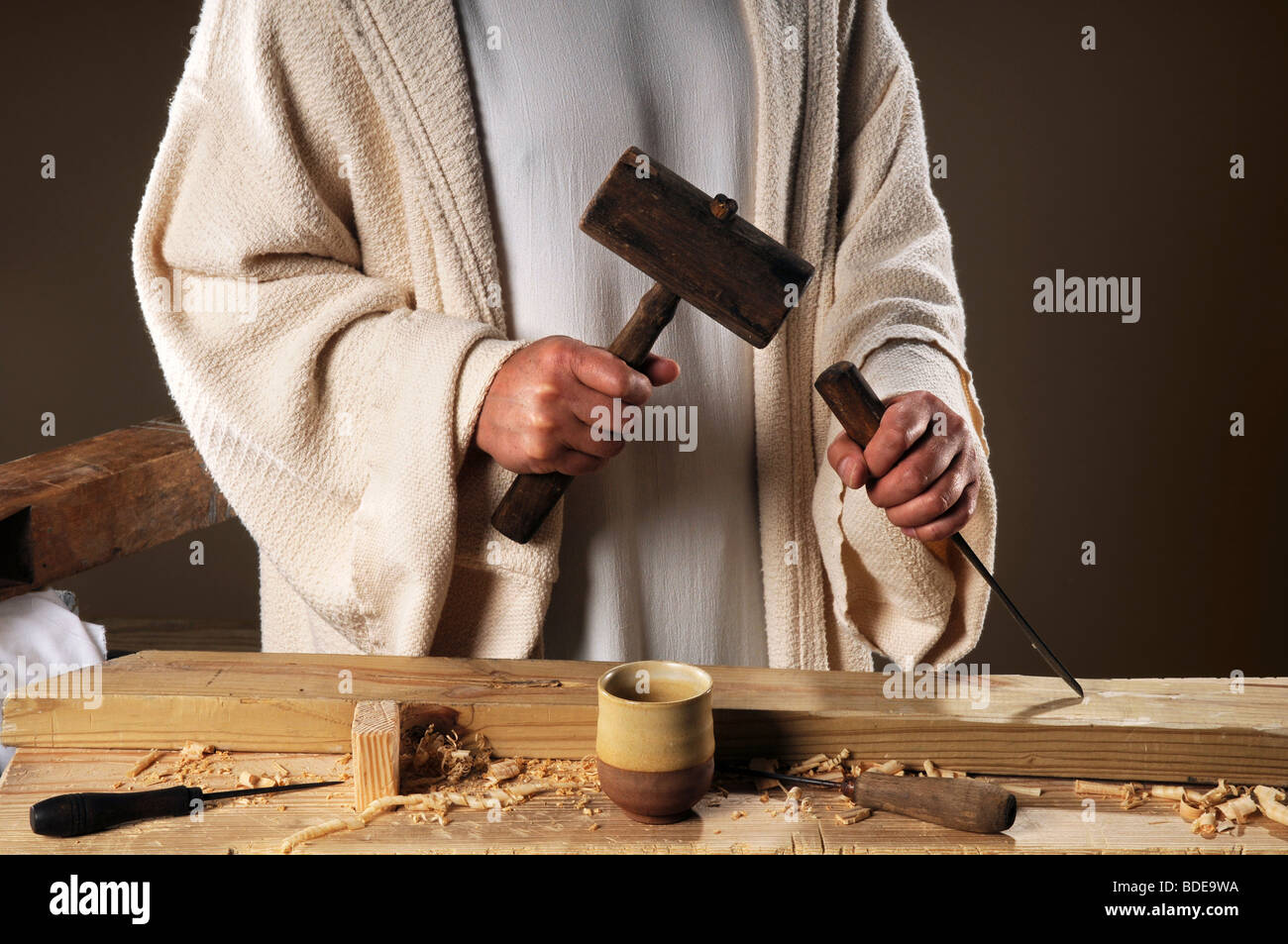Jesus hands with wooden mallet and chisel Stock Photo
