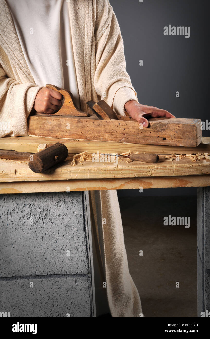 Jesus the carpenter working with a wood plane on a bench Stock Photo Alamy