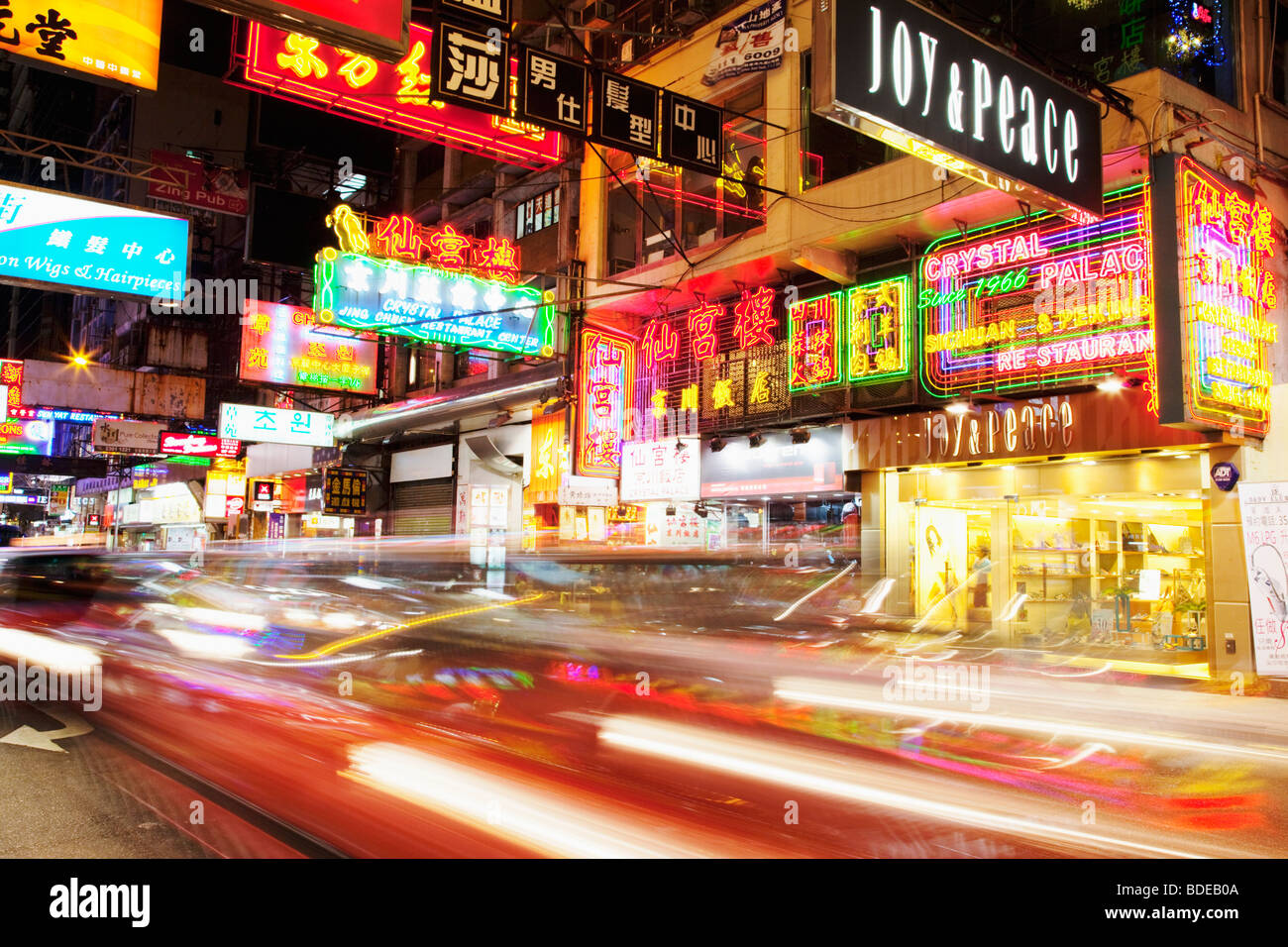 Neon signs and car light trail in Tsim Sha Tsui, Kowloon, Hong Kong, China. Stock Photo