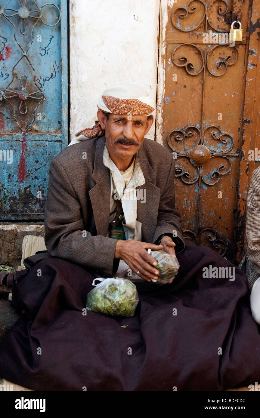 A portrait of a merchant holding a bag of khat - a chewable leafy stimulant and legal drug - in the old market in Sanaa, Yemen. Stock Photo
