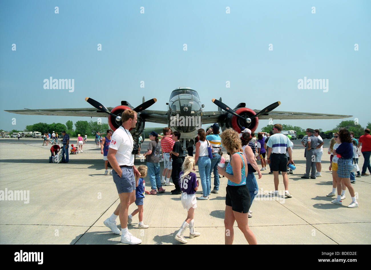 Crowd forms in front of a restored B25 Mitchell bomber at an air show ...