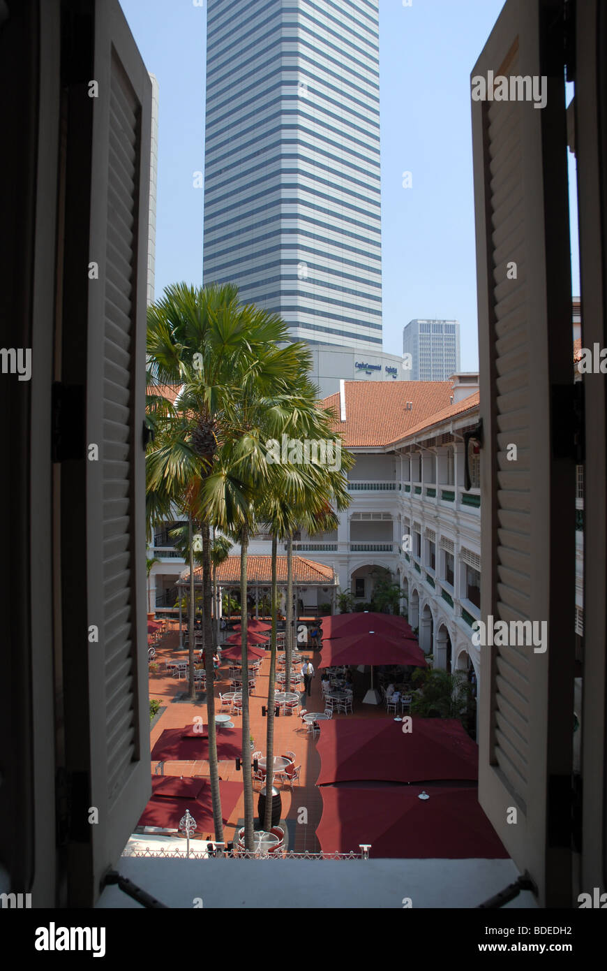 view through second storey window to courtyard and gazebo bar of Raffles Hotel, Singapore Stock Photo