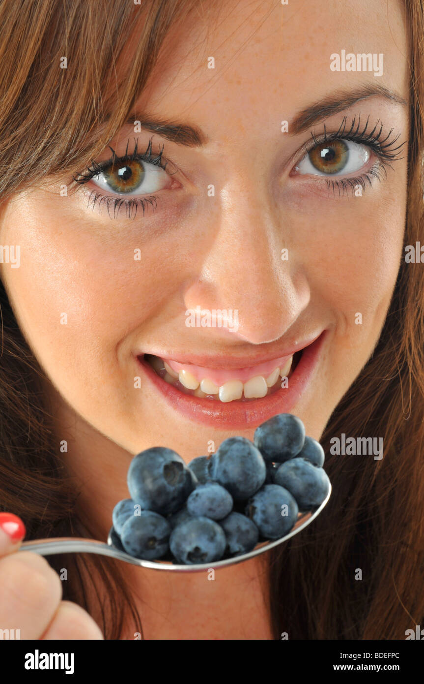 Blueberries, Woman with a spoonful of blueberries Stock Photo