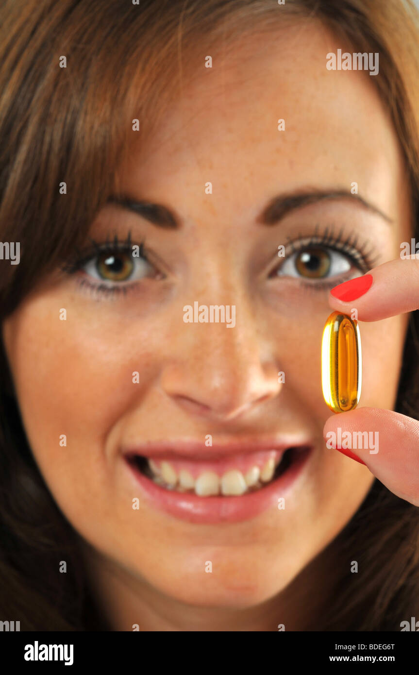 'fish oil' 'fish oil capsules' Woman holding 'fish oil' capsules Stock Photo