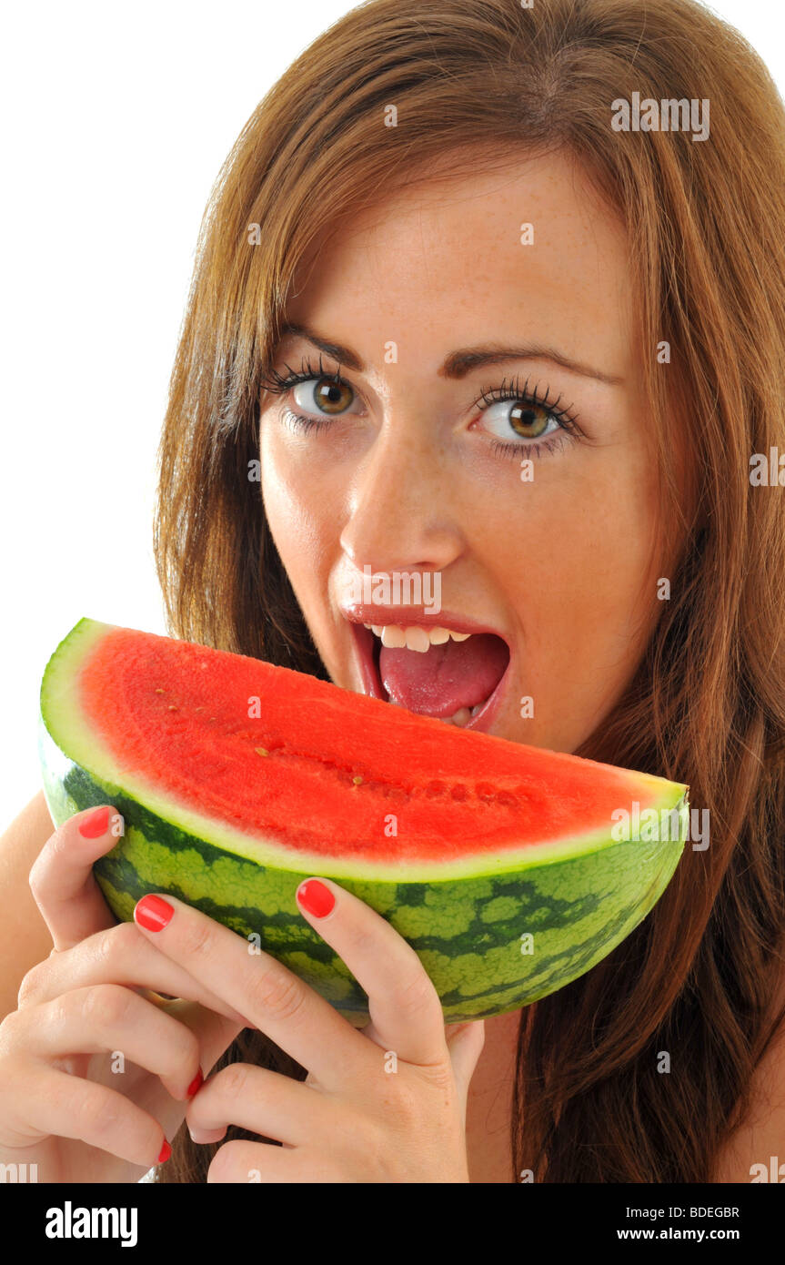 Woman about to take a bite out of a slice of watermelon, melon, 'water melon' Stock Photo