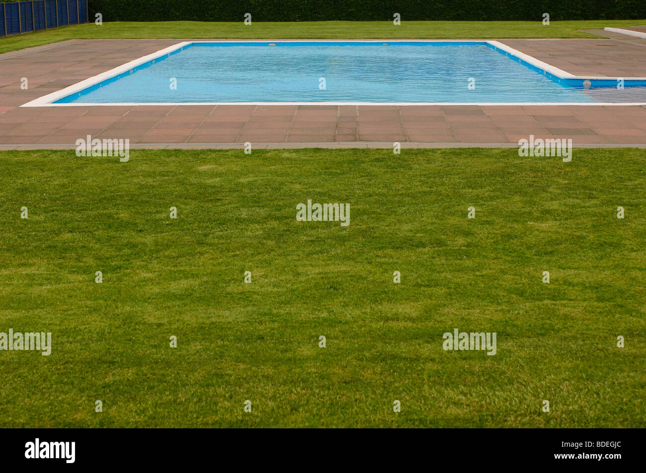Childrens municipal paddling pool surrounded by grass Stock Photo Alamy
