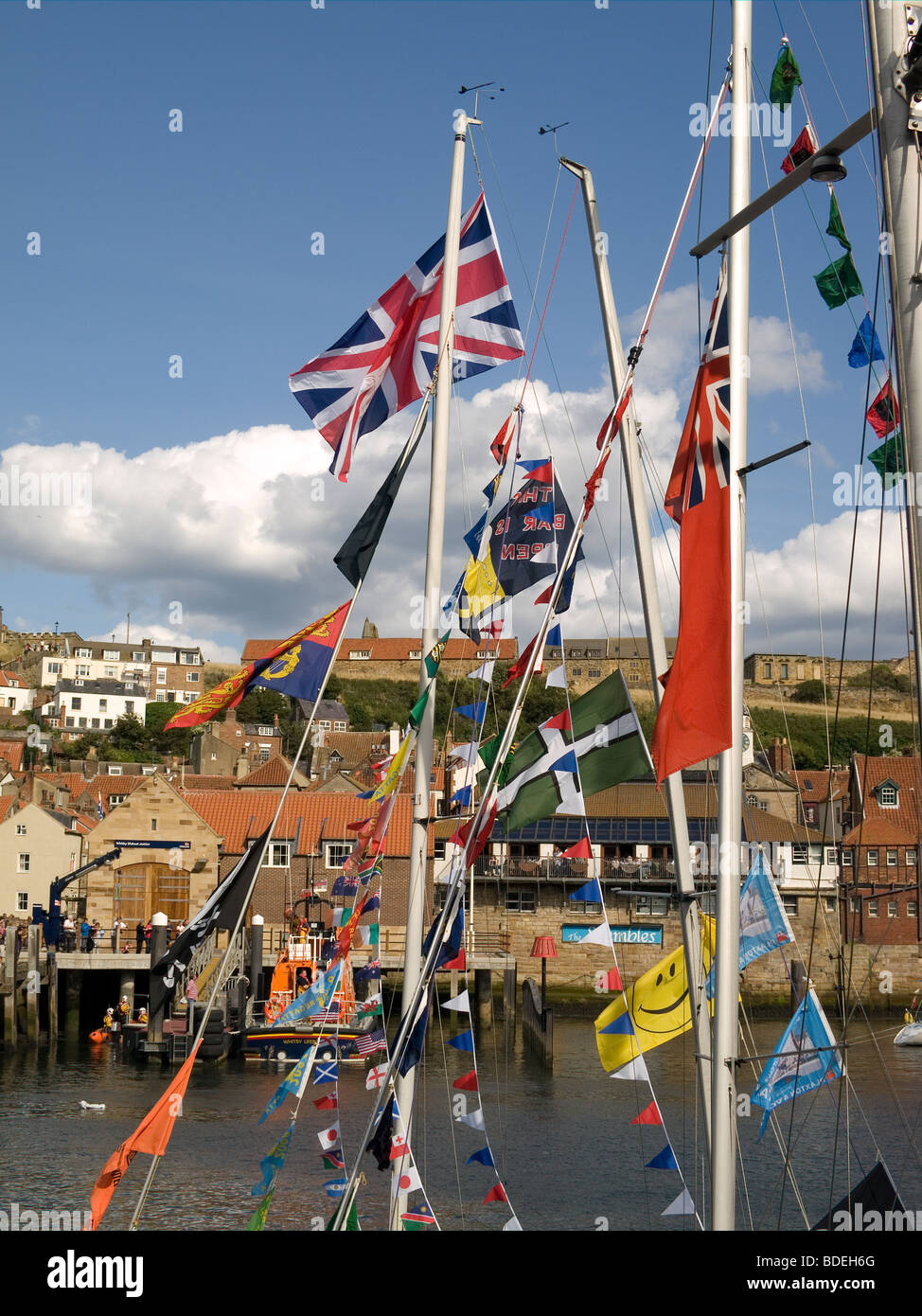 Whitby town seen through flags and bunting on yachts in harbour for the 169th annual Regatta August 2009 Stock Photo