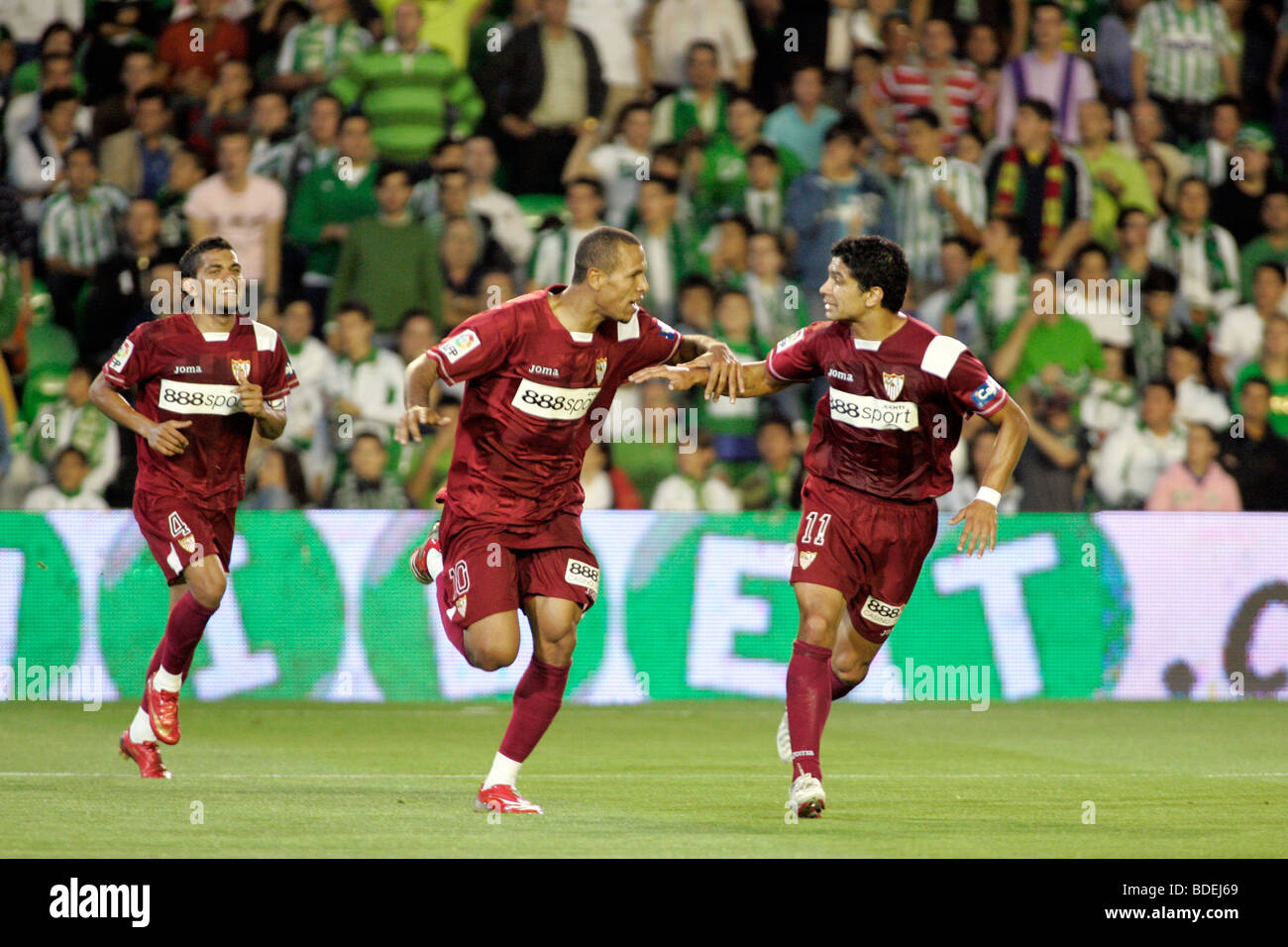 Daniel Alves, Luis Fabiano and Renato celebrating a goal. Local derby between Real Betis and Sevilla FC, Ruiz de Lopera Stock Photo