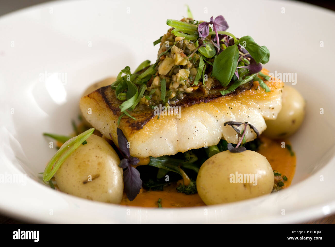 Sea Bass with new potatoes Stock Photo Alamy