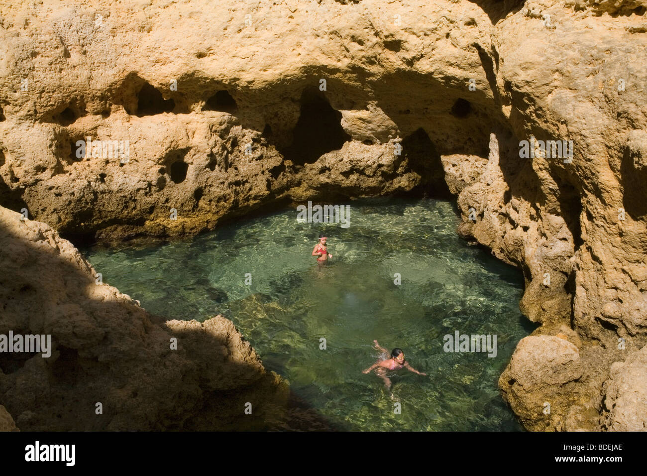 Portugal Algarve Carvoeiro Algar Seco rock pool & swimmers Stock Photo