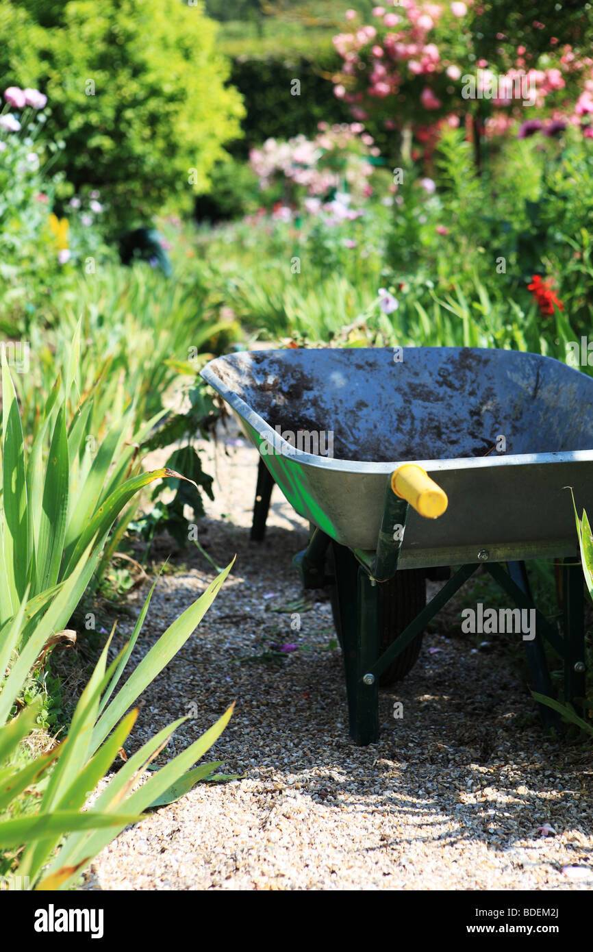 Wheelbarrow in garden Stock Photo Alamy