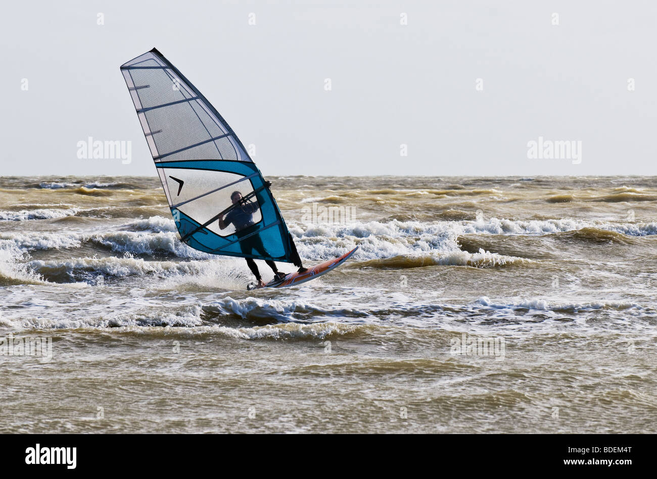 A windsurfer in the sea off Camber Sands in Sussex.  Photo by Gordon Scammell Stock Photo
